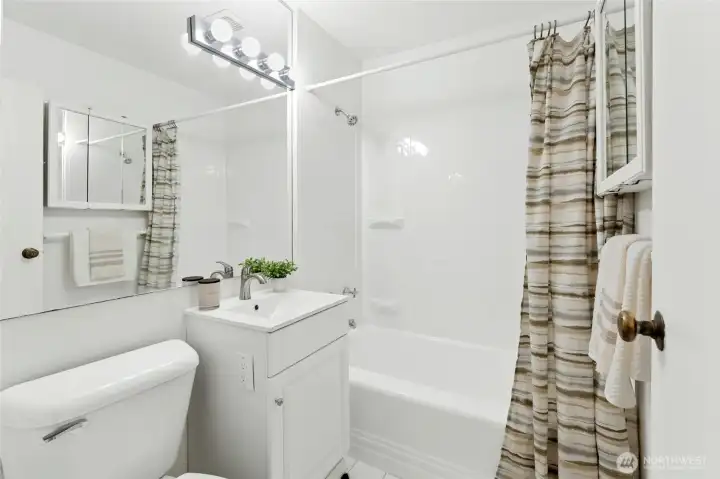 New vanity and tub surround in full bath.