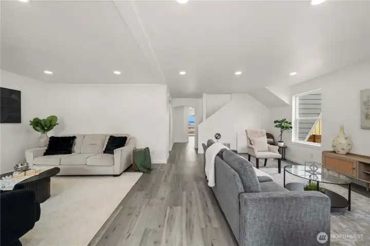 Bright and versatile living space with contemporary finishes, expansive seating areas, and an open flow throughout the lower level.