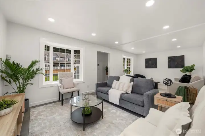 The beautiful lighting enhances the room’s airy feel, and the cute entry space provides a perfect opportunity for functional seating or coat storage.