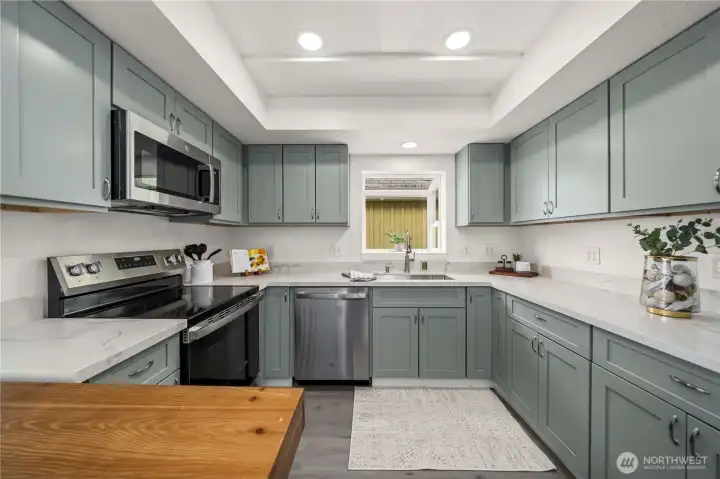 Fully remodeled kitchen with a charming garden window brings warmth, character, and beautiful natural light into the space.
