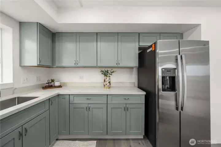 Thoughtfully designed kitchen offers extensive cabinetry and expansive counter space for effortless meal prep and organization.
