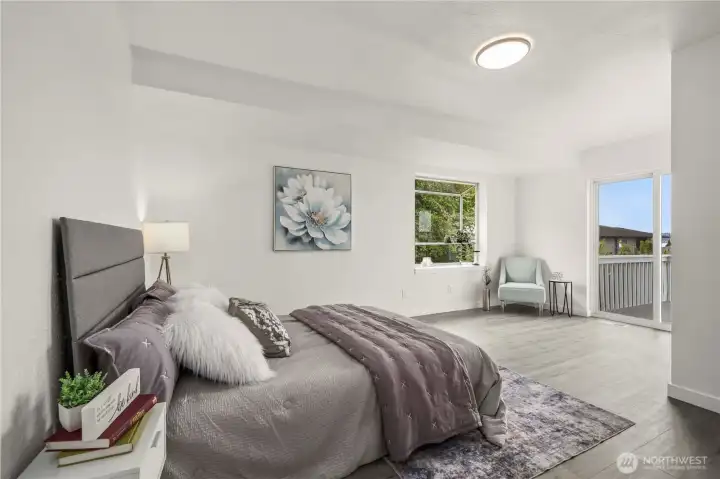 Main-floor junior suite features a large garden window, abundant natural light, and easy access to the deck for indoor-outdoor living.