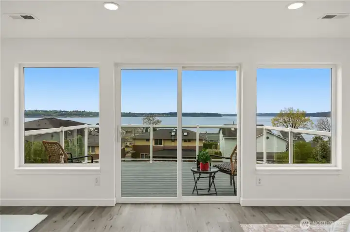 Enjoy sweeping views from the private deck in the primary bedroom— an unforgettable setting best appreciated in person.