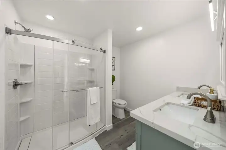 Beautifully updated primary bath showcases dual vanities and thoughtful contemporary upgrades.