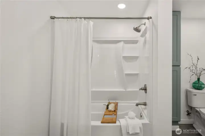 Spacious upstairs full bathroom with convenient extra storage and stylish finishes.