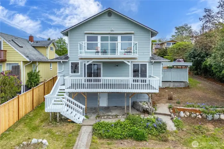 From the backyard, you can truly appreciate the expansive deck space, generous yard, and potential future subdivision opportunity — buyer to verify feasibility with city/county.