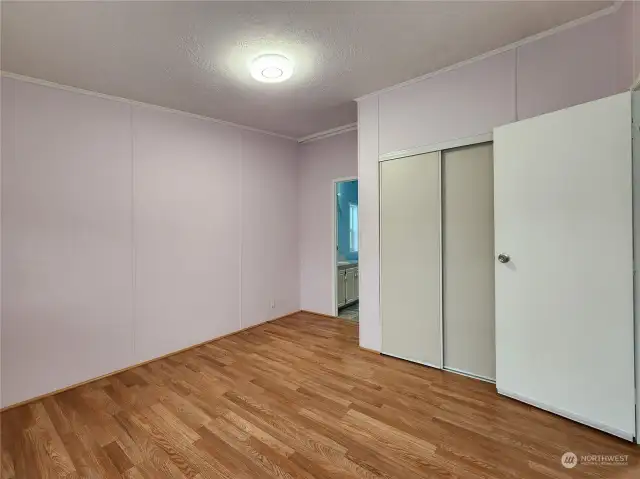 Wide angle view looking into the primary bath from primary bedroom