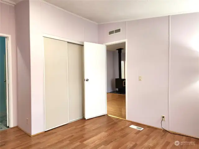 The large closet in the primary bedroom. Easy care laminate flooring