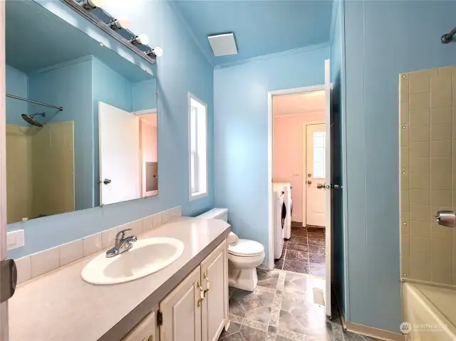 The primary bathroom can also access the laundry room and easy access to the back proch