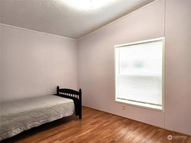 Guest bedroom One both additional bedrooms have great closet space and easy care laminate flooring