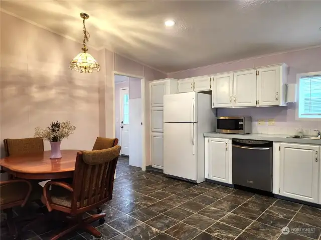 The white kitchen has heavy easy care vinyl flooring that looks like real tile. All the kitchen appliances are included