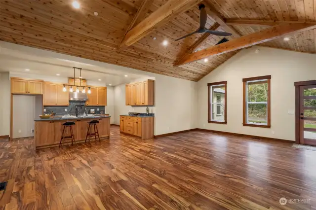 Living room facing kitchen with high ceiling