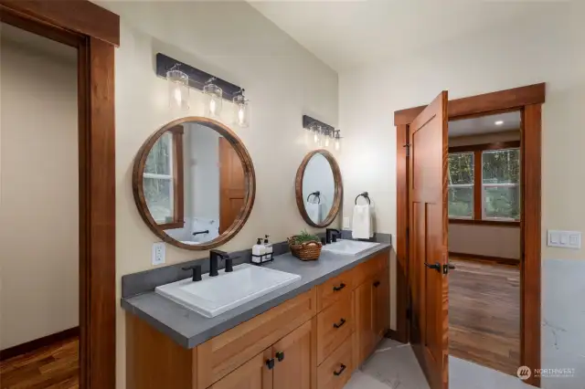 Primary bath with twin sinks. Custom cabinets!