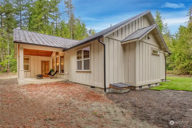 Large two-car garage. Closet with water heater and tanks holding water for inside sprinkler system