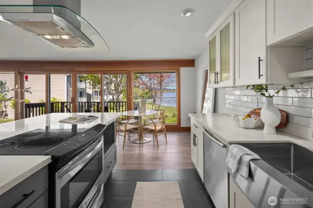 This beautifully remodeled kitchen is a cook’s dream, featuring sleek quartz counters, elegant tile floors, stainless steel appliances, an oversized undermount sink, soft-close cabinets, and subtle undermount lighting.