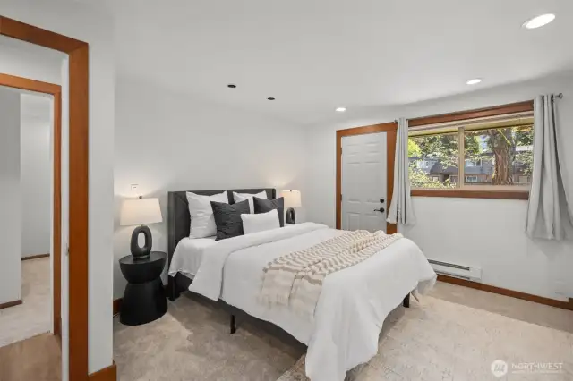 The spacious primary suite easily accommodates furniture of any size and features a large walk-in closet, brand new carpet and fresh paint—plus a private front deck to enjoy your own peaceful retreat.