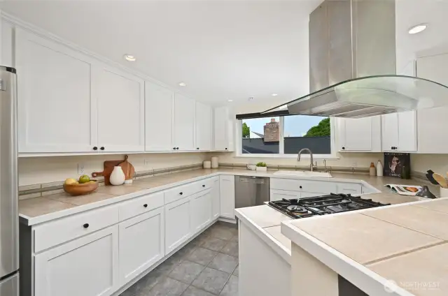 Kitchen has gas with newer cooking hood.