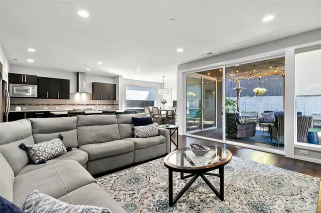 Double sliding glass doors open to create a huge indoor / outoor space.