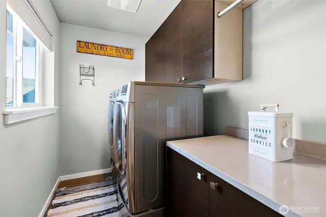 Large laundry room with full size washer and dryer.