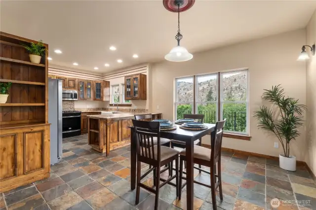 Kitchen with bar seating and dining area