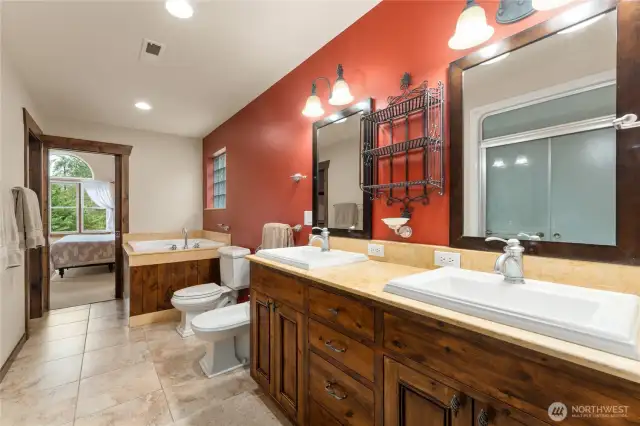 Primary bathroom with jetted tub, dual vanity, shower and walk in closet