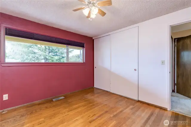 Primary bedroom with hardwood floors