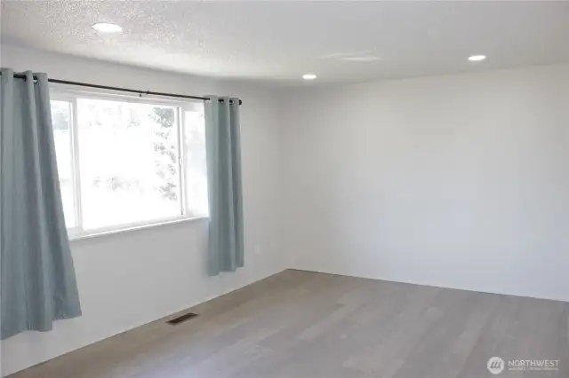 Spacious living room with recessed lighting.