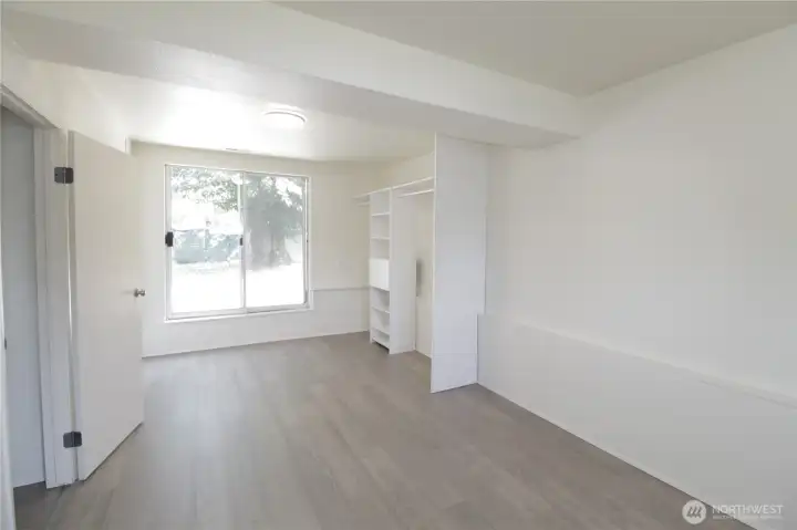 Bedroom 3 downstairs with slider to backyard.