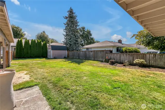 Fenced backyard for safe enjoyment by children, grandchildren, or pets.