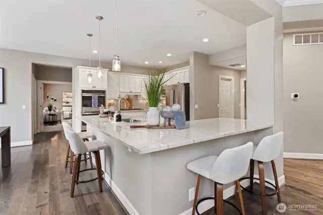 Light-filled and thoughtfully designed, the kitchen features quartz counters, stainless appliances, and ample prep space. Perfect for weekday meals or weekend hosting.