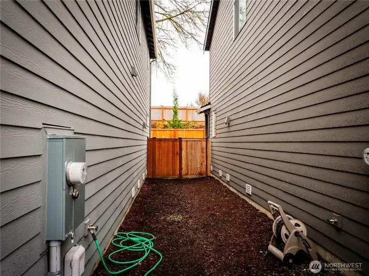 SIDE YARD WITH GATE TO BACKYARD...
