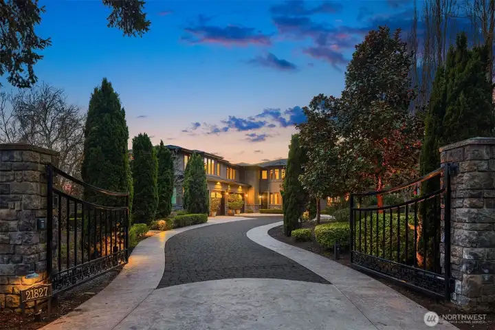 A gently curving driveway leads from the main road to the estates grand entrance beginning with an impressive wrought iron gate and custom brick pavers.