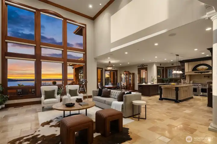 Well-appointed open floor plan with a two-story great room featuring a four-zone sound system and travertine flooring throughout the main level.