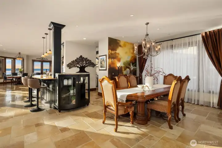 The formal dining room exudes warmth and old-world elegance with a breathtaking hand painted Tuscan mural that transforms the space into an Italian countryside retreat.