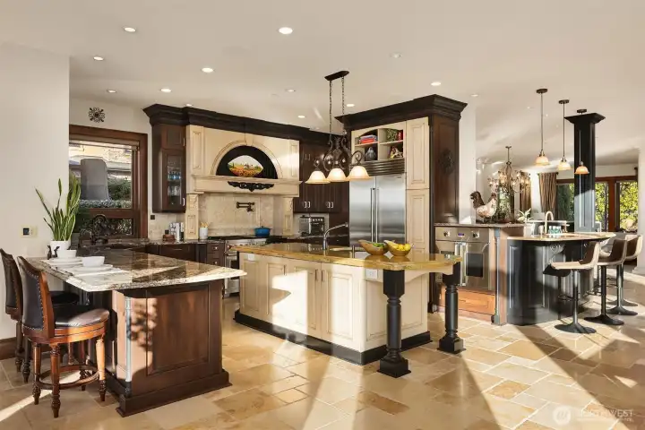 This stunning kitchen features a Wolf 48" range with two self-cleaning ovens, pot filler, Viking oven, Sub-Zero refrigerator, Artison coffee machine, Marvel ice maker and beverage cooler. Not to mention 4 custom hand hammered copper sinks and an instant hot water with filtering, one with filtered drinking water.