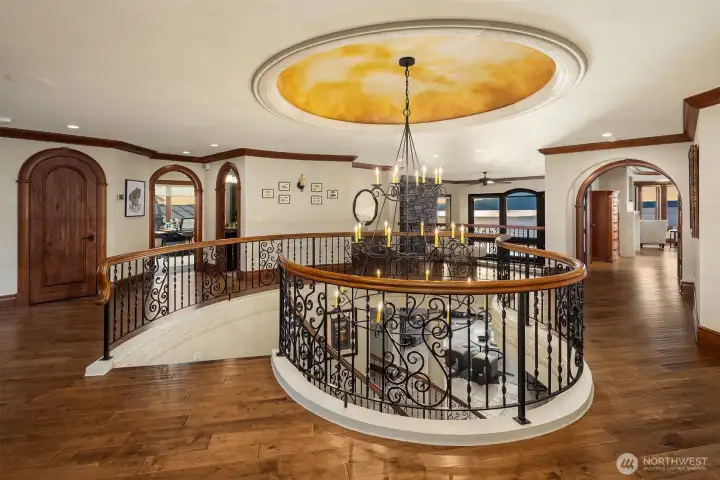 Astounding upper level continues with arched architectural entryways, extensive millwork, wood handrail wraps and a most eye stunning hand painted ceiling dome.