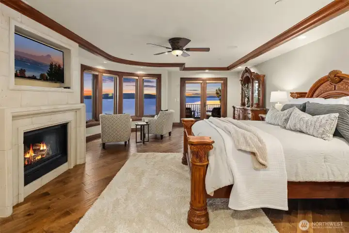 Presenting the primary suite! A true retreat where you can get away and relax in your own private space. This amazing suite features custom coffered ceiling, sound/entertainment system, concrete fireplace, and double French doors to veranda.