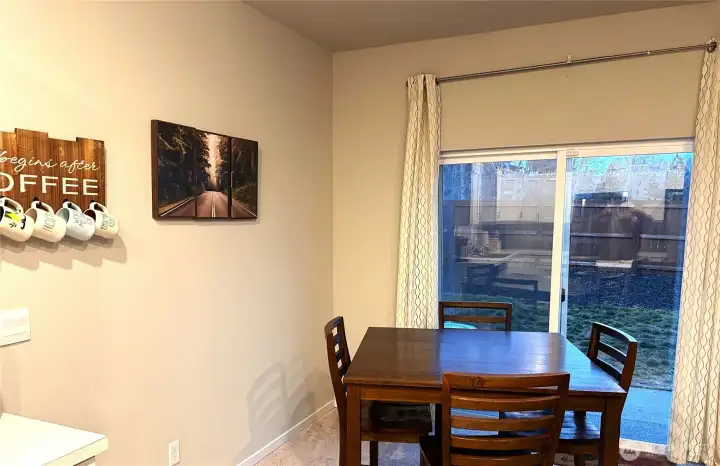 Dining area by kitchen has a view & access to the fenced back yard.