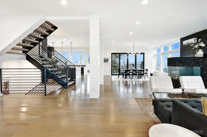 Open concept living area with statement staircase