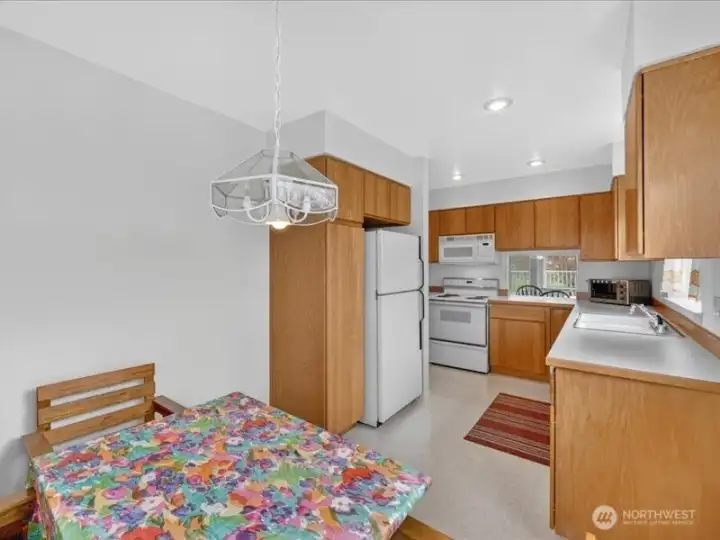 There is an informal dining area in the kitchen beyond the pantry storage cabinets. There is an informal dining area in the kitchen beyond the pantry storage cabinets.