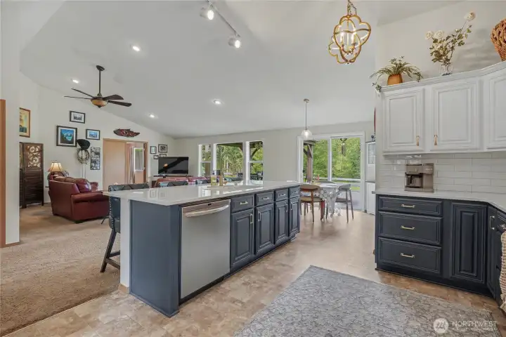 Kitchen view two from dining towards your family room. Open concept design that is perfect for entertaining, LARGE windows and patio doors bring in all the views and light. Plenty of eat-in kitchen space as well.