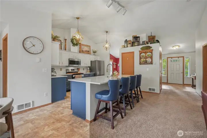 Kitchen view three from your eat-in kitchen, those amazing stools can stay! Main entry to your right, hall to your garage and powder room to your left.