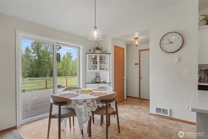Eat-in kitchen space view, I love the huge patio doors, coat closet and door to garage straight ahead, short grocery commute!