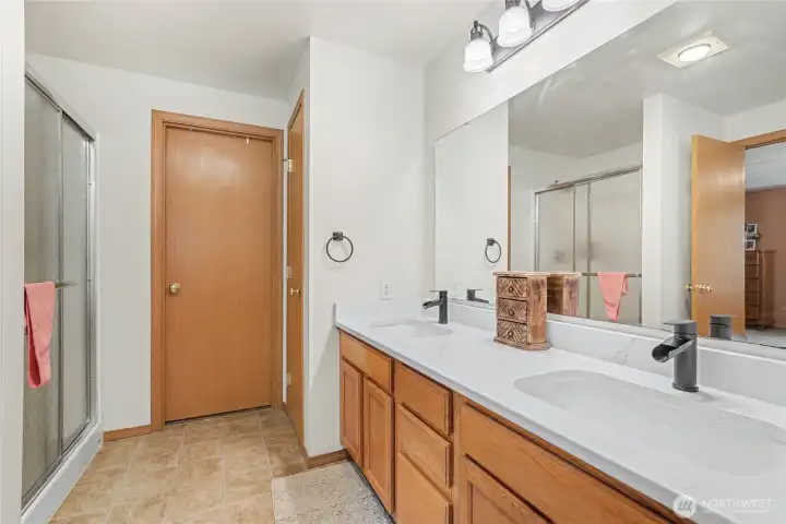 Primary ensuite bath view one, love the double vanity with quartz counters and all the cabinet storage.
