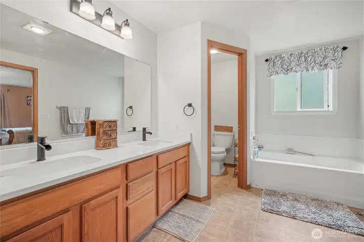 Primary ensuite bath view two showing soaking tub and most important Marriage Saver separate water closet!