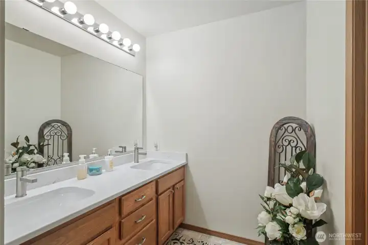 Kids/guest full bath view one, nice double vanity with quartz counters and great cabinetry.