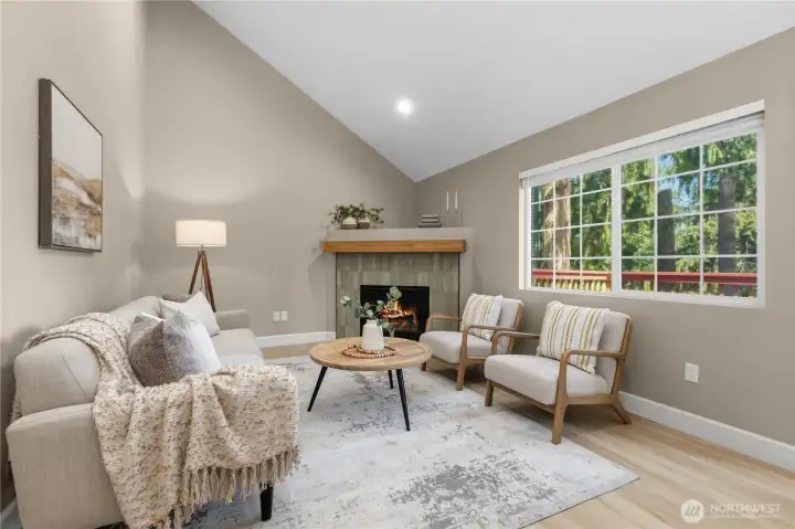 Comfortable main living space with a warm fireplace focal point and large windows bringing the outdoors in.