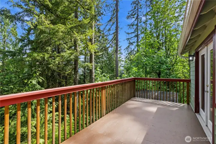 Generous deck space provides room for outdoor seating, dining, and enjoying the natural setting year-round.