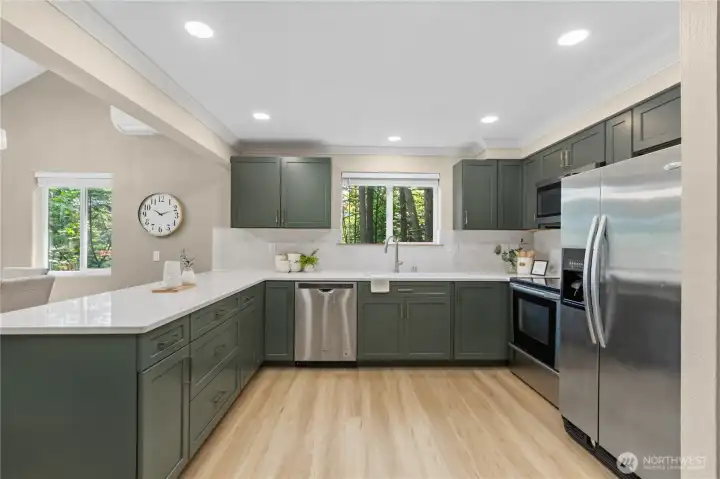 Stainless steel appliances and updated finishes create a clean, modern aesthetic.