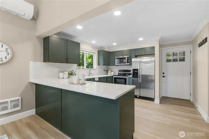 Oversized island anchors the kitchen while providing flexible seating and serving space